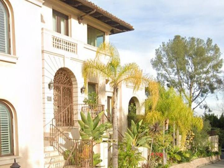 A Spanish-style home with palms in Benedict Canyon