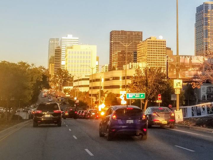 Century City towers at sunset above a busy street