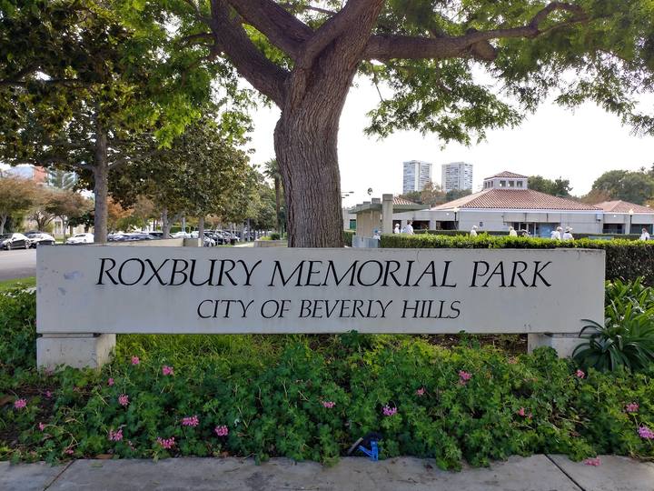 The Roxbury Memorial Park sign under an oak in Beverly Hills